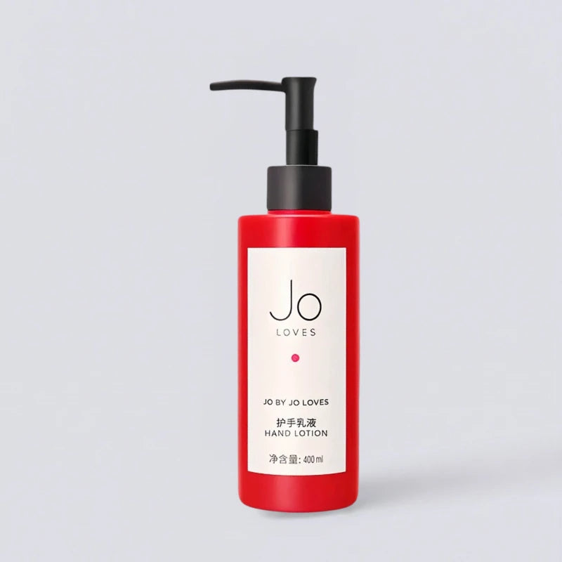 Jo Loves Red Edition Hand Lotion 400ml, luxury hotel bathroom essentials. Zesty citrus scent for a pure hand ritual in a signature red bottle by Luxe Hotel Essentials.